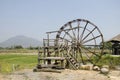 Big wooden turbine baler water wheel at Thai Dam Cultural Village in Chiang Khan at Loei, Thailand Royalty Free Stock Photo