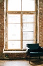 Big wooden window with white sofa in old vintage living room with brick walls Royalty Free Stock Photo