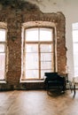 Big wooden window with white sofa in old vintage living room with brick walls Royalty Free Stock Photo