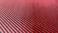 Red woven Black carbon fiber composite material background close up view Royalty Free Stock Photo