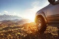 Big 4x4 car against sunset and mountains Royalty Free Stock Photo