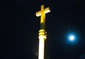 Big yellow cross against the moon, dark sky, at night. Bangkok Royalty Free Stock Photo