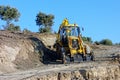 Big Yellow Digger Excavating New Dirt Road Royalty Free Stock Photo