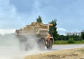 Big yellow dump truck working in the limestone open-pit. Loading and transportation of minerals in the dolomite mining quarry. Royalty Free Stock Photo