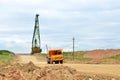 Big yellow dump truck working in the limestone open-pit. Loading and transportation of minerals in the dolomite mining quarry. Royalty Free Stock Photo