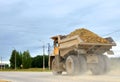 Big yellow dump truck working in the limestone open-pit. Loading and transportation of minerals in the dolomite mining quarry. Royalty Free Stock Photo
