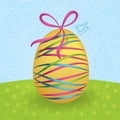 Big yellow easter egg with colorful ribbons Royalty Free Stock Photo