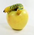 Big yellow-green dead-head moth Acherontia atropos caterpillar on a yellow apple close-up on white macro, pest,