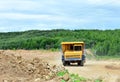 Big yellow mining truck working in the limestone open-pit. Loading and transportation of minerals in the dolomite mining quarry. Royalty Free Stock Photo