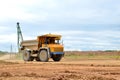 Big yellow mining truck working in the limestone open-pit. Loading and transportation of minerals in the dolomite mining quarry. Royalty Free Stock Photo