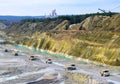 Big yellow mining trucks working in the limestone open-pit. Loading and transportation of minerals in the chalk open-pit. Royalty Free Stock Photo