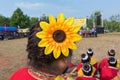 Big yellow plastic flower decorated on woman head