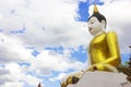 Big Yellow sitting Budha image and Blue sky
