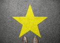 Big yellow star on floor with businessman shoes Royalty Free Stock Photo