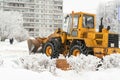 Big yellow tractor cleans snow on city streets russia