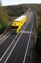 A big yellow truck on the Chiers viaduct in Longwy in Meurthe et Moselle Royalty Free Stock Photo