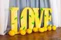 Big yellow word Love and fresh lemons
