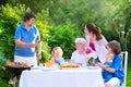 Big young family grilling meat for lunch Royalty Free Stock Photo