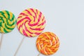 Big yummy lollipops on sticks. Sweet caramel candy on white. Cop Royalty Free Stock Photo