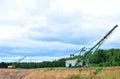 Biggest excavator dragline with a large bucket for the quarry overburden stripping.