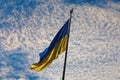 The Biggest National flag Ukraine against blue sky with fantastic soft clouds. Blue and yellow flag of Ukraine. Royalty Free Stock Photo