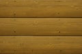 Quarter pine log siding with a yellow stained finish