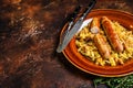 Bigos Stewed cabbage with mushrooms and meat sausages on a plate. Dark background. Top view. Copy space Royalty Free Stock Photo