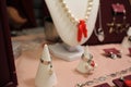 Bijouterie on a red background. Decorations at the fair. Handmade products. Hobby. Fashionable accessories. Earrings and