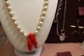 Bijouterie on a red background. Decorations at the fair. Handmade products. Hobby. Fashionable accessories. Earrings and
