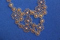 Bijoux necklace on a blue fabric background Royalty Free Stock Photo