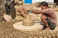 Indian potter making clay pots on pottery wheel in Bikaner. Rajasthan. India