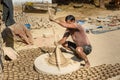 Indian potter making clay pots on pottery wheel in Bikaner. Rajasthan. India