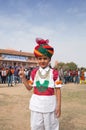 Smiling Indian Rajasthani boy poses for a photo during Camel Festival in Rajasthan, India