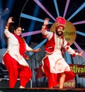 Sikh artists performing Bhangra dance on stage