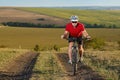 Bike adventure travel photo. Cyclist on the Beautiful Meadow Trail on sunny day. Royalty Free Stock Photo