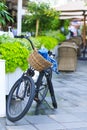 Bike with a basket stopped on the street next to the cafe Royalty Free Stock Photo