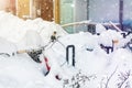 Bike covered with big thick snow layer after blizzard at european city street in winter. Abandoned bicycle buried in snowstorm Royalty Free Stock Photo