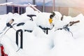 Bike covered with big thick snow layer after blizzard at european city street in winter. Abandoned bicycle buried in snowstorm Royalty Free Stock Photo