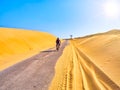 Bike crossing an arid dune terrain