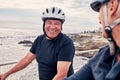 Bike, cycling and beach with a old couple riding outdoor on the promenade during summer for exercise. Bicycle, fitness Royalty Free Stock Photo