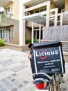 bike delivery parked in front of flats houses homes showing hot box with licious logo showing the indian startup food tech