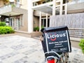 bike delivery parked in front of flats houses homes showing hot box with licious logo showing the indian startup food tech