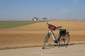 Bike at the edge of a field road near a plowed and sown field