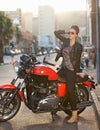 Bike, fashion and woman in city with sunglasses for travel, transport or road trip as rebel. Leather, asphalt and model Royalty Free Stock Photo