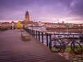 Bike and a fir tree on a wooden dock near a river in Deventer, the Netherlands