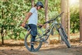 Bike, fitness and man in forest, stretching and workout for balance, cardio and energy for wellness. Male biker, guy and