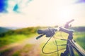 Bike handle bar at sunset on mountain trail. details of sport activities Royalty Free Stock Photo