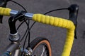 bike handlebar detail with bright yellow bar tape (bicycle cockpit, cycling) shifters, brifters, black quill stem Royalty Free Stock Photo