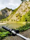 Bike handlebars and a gorgeous stunning green mountain view near a river landscape composition. Biker travelling, summer biking