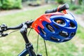 Bike helmet hangs from the handlebars of a bicycle